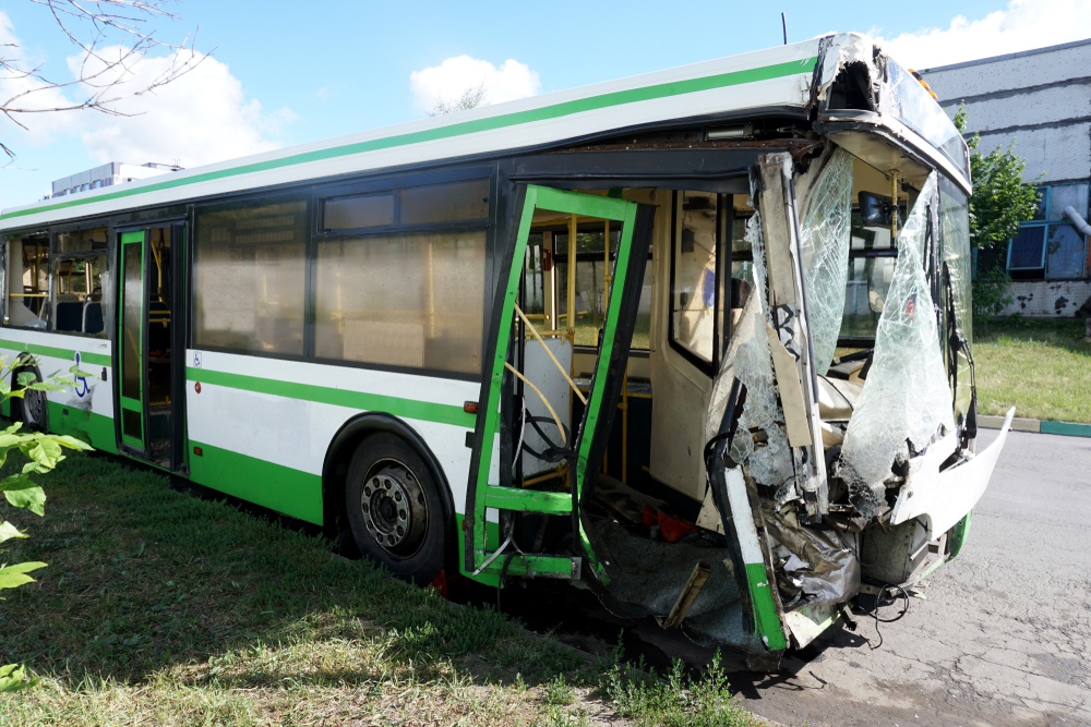 A bus, completely demolished in the front section, after a bus accident.