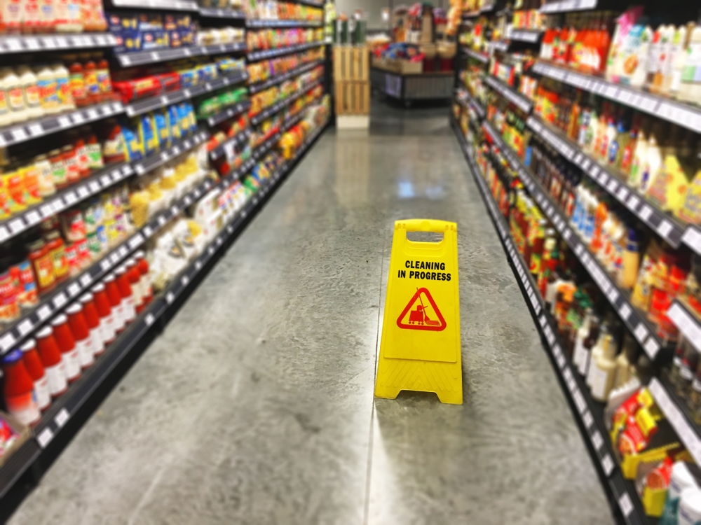 A wet floor sign displayed at a grocery store.