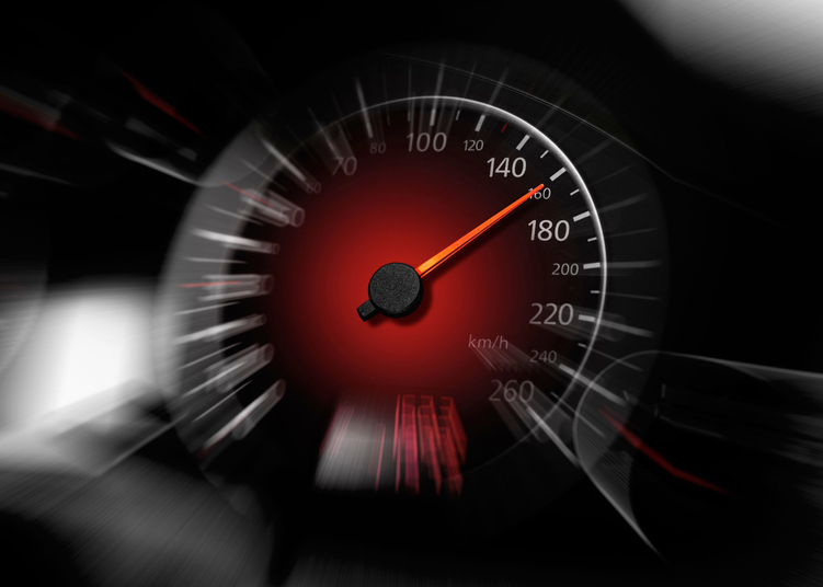 The speedometer of a modern car shows a high driving speed. Added motion blur.